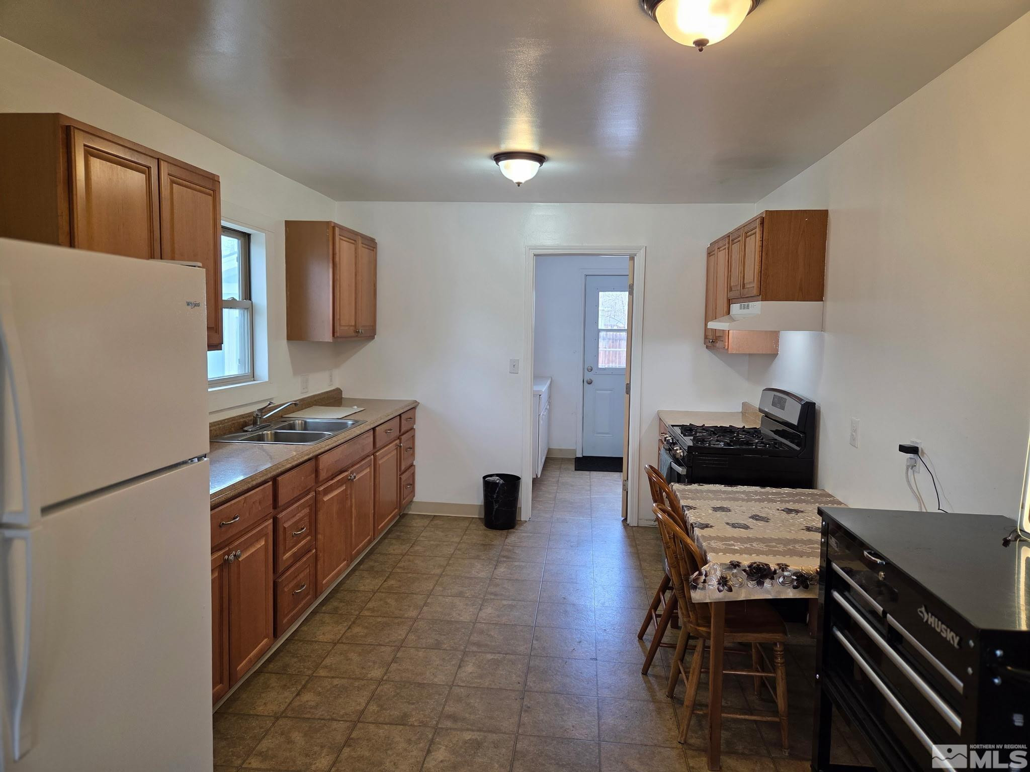 1810 Montello Street Reno, NV 89512 - Photo 6 of 22 a kitchen with a refrigerator and a stove top oven
