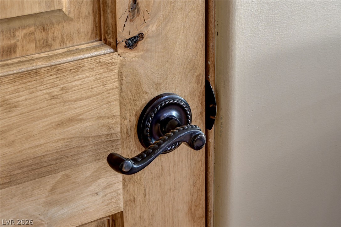 1950 Bowman Road Logandale, NV 89021 - Photo 15 of 98 A dark, ornate door handle adorns a rich wooden door, offering a touch of classic elegance.