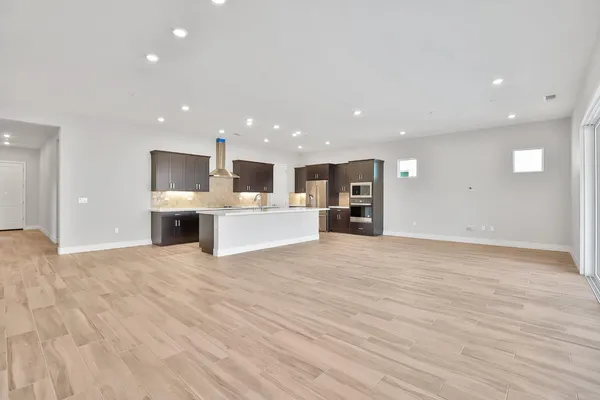 a view of kitchen with kitchen island microwave and refrigerator