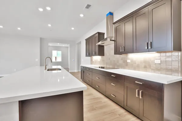 a large kitchen with cabinets a sink and dishwasher