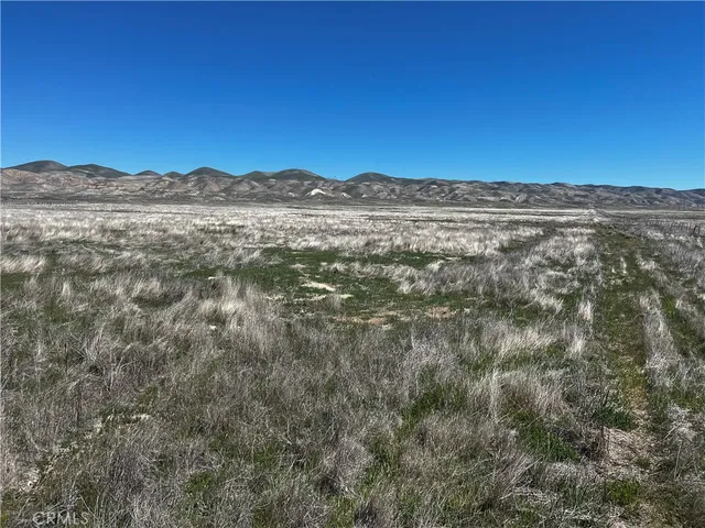 a view of mountain with sunset in background