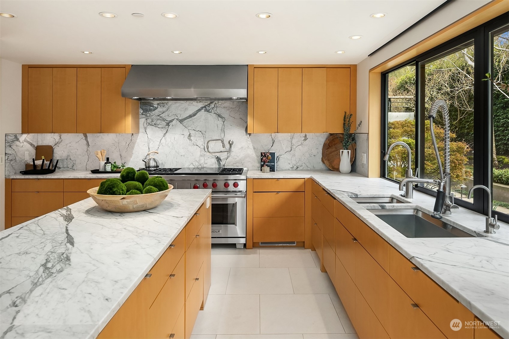 1829 Evergreen Point Road Medina, WA 98039 - Photo 12 of 39 a kitchen with a sink a counter top space a stove and a large window