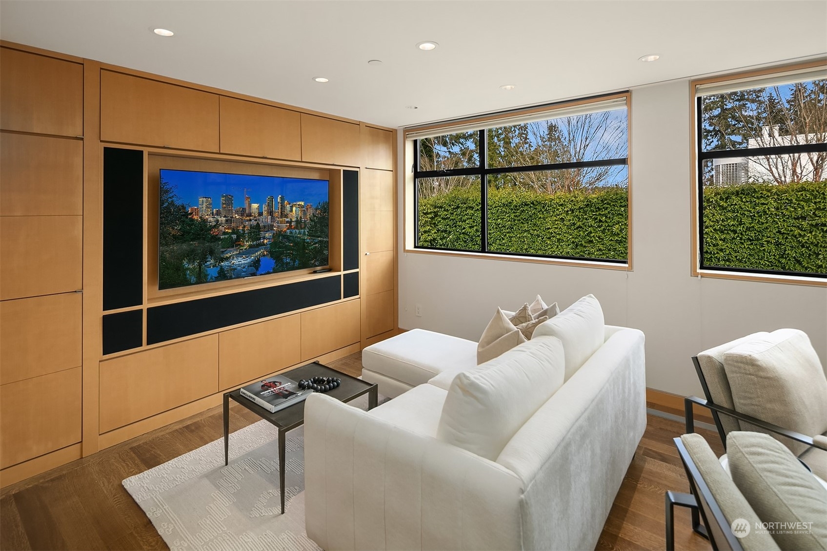 1829 Evergreen Point Road Medina, WA 98039 - Photo 27 of 39 a living room with furniture a flat screen tv and a floor to ceiling window