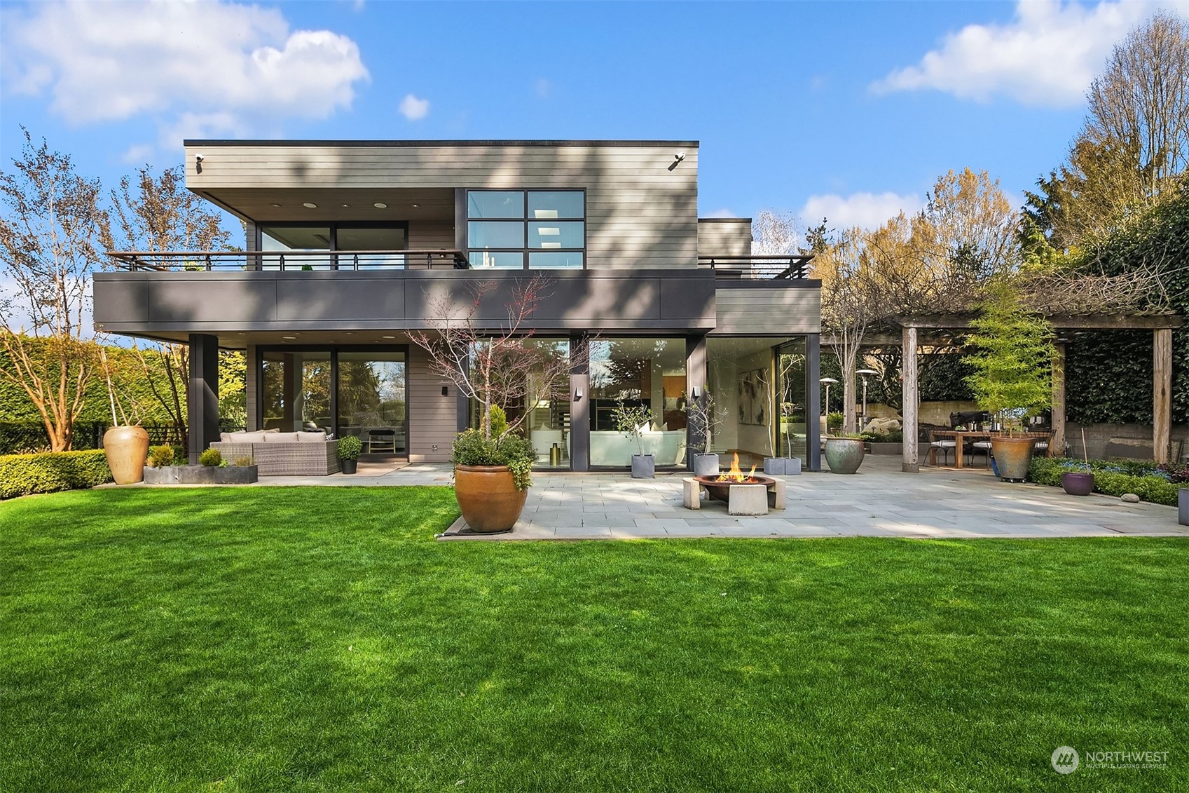 1829 Evergreen Point Road Medina, WA 98039 - Photo 37 of 39 a view of a chair and table in backyard of the house
