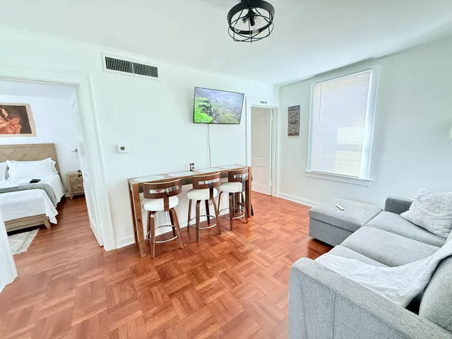 a living room with furniture and a wooden floor