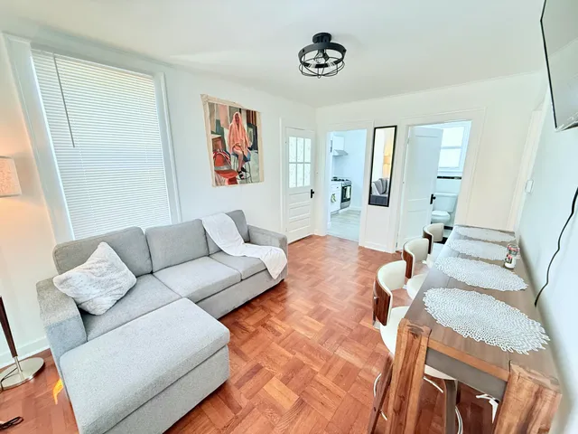 a view of a hallway with wooden floor and a window