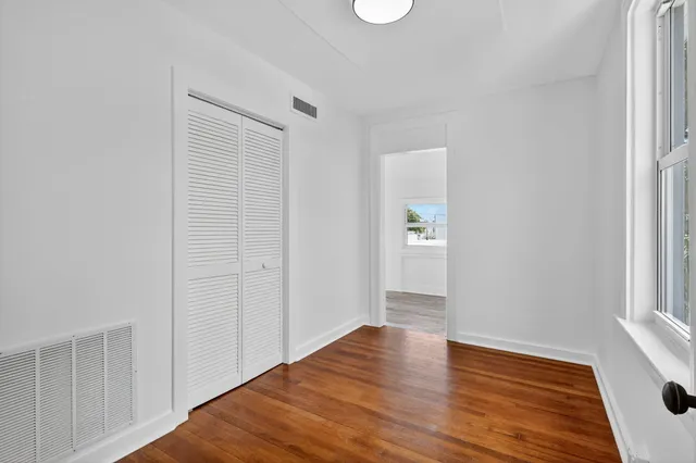 a room with wooden floor and furniture