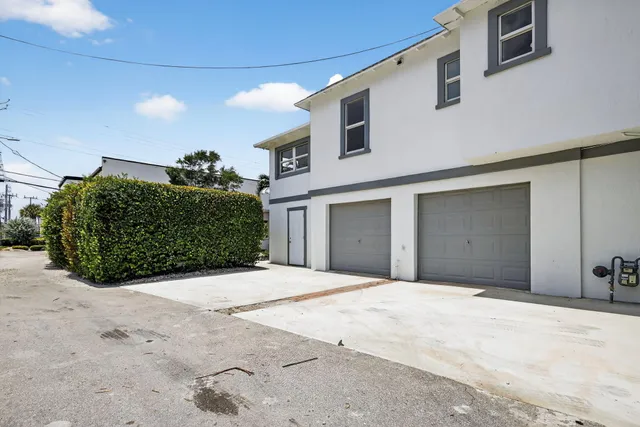 an aerial view of a house with a yard and fountain in the background