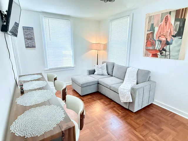 a living room with furniture and a rug
