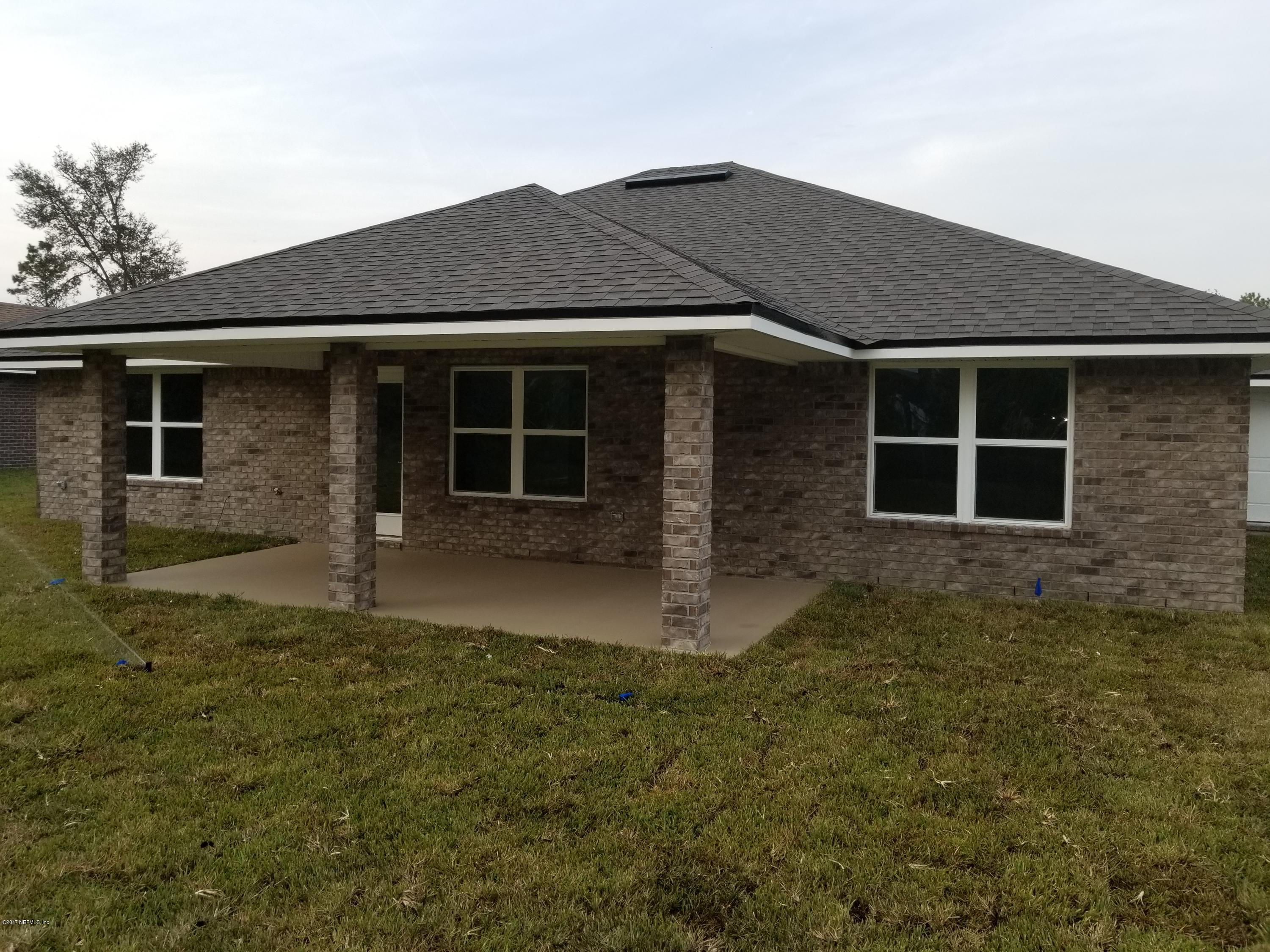 88051 Maybourne Road Yulee, FL 32097 - Photo 18 of 22 a front view of a house with a yard