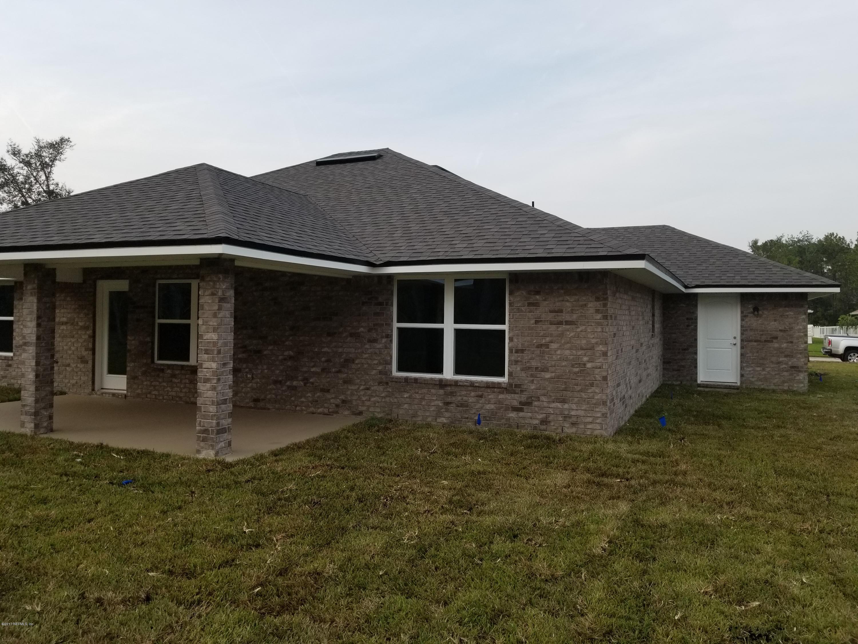 88051 Maybourne Road Yulee, FL 32097 - Photo 19 of 22 a front view of a house with a garden