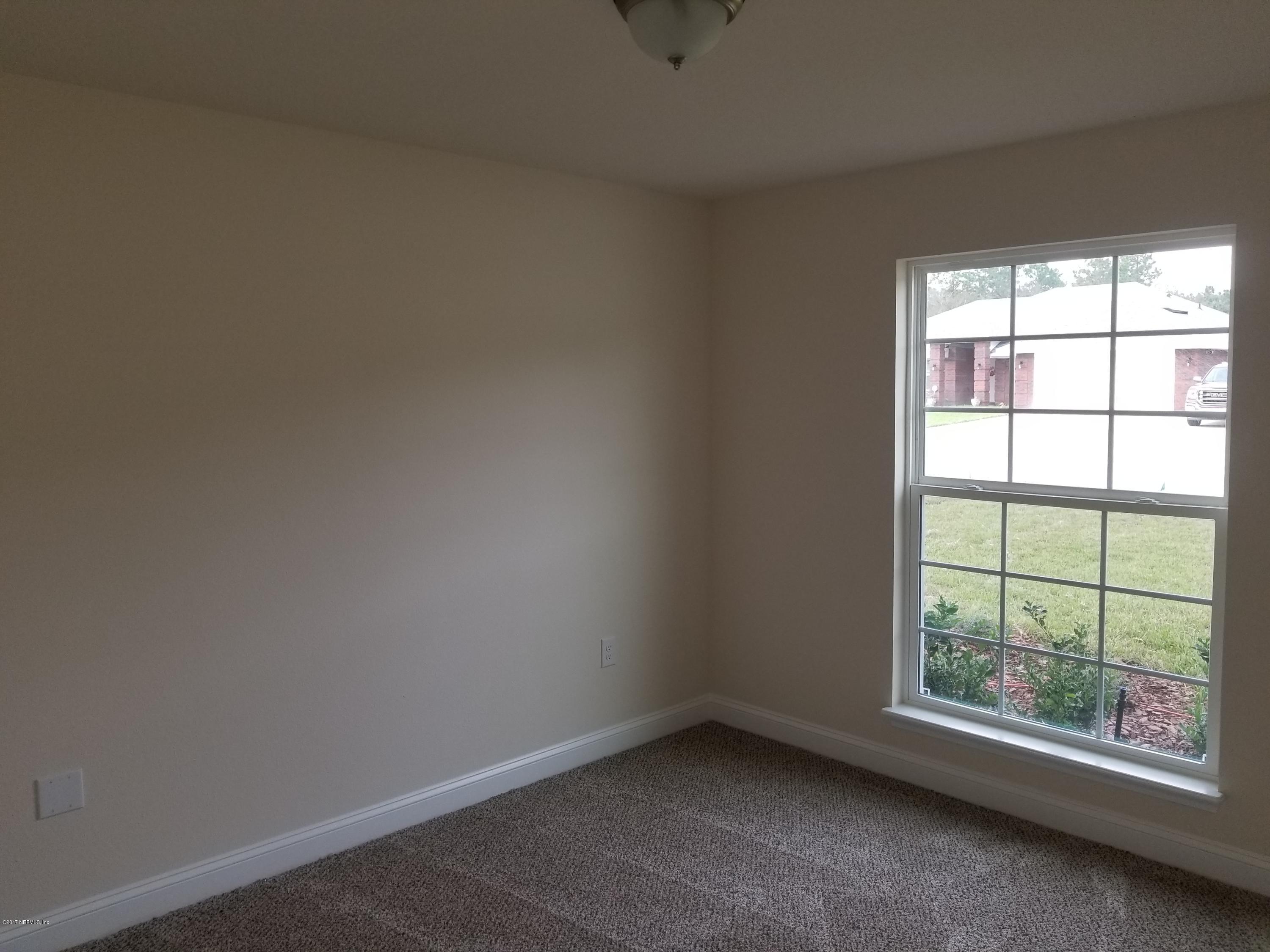 88051 Maybourne Road Yulee, FL 32097 - Photo 5 of 22 an empty room with a window