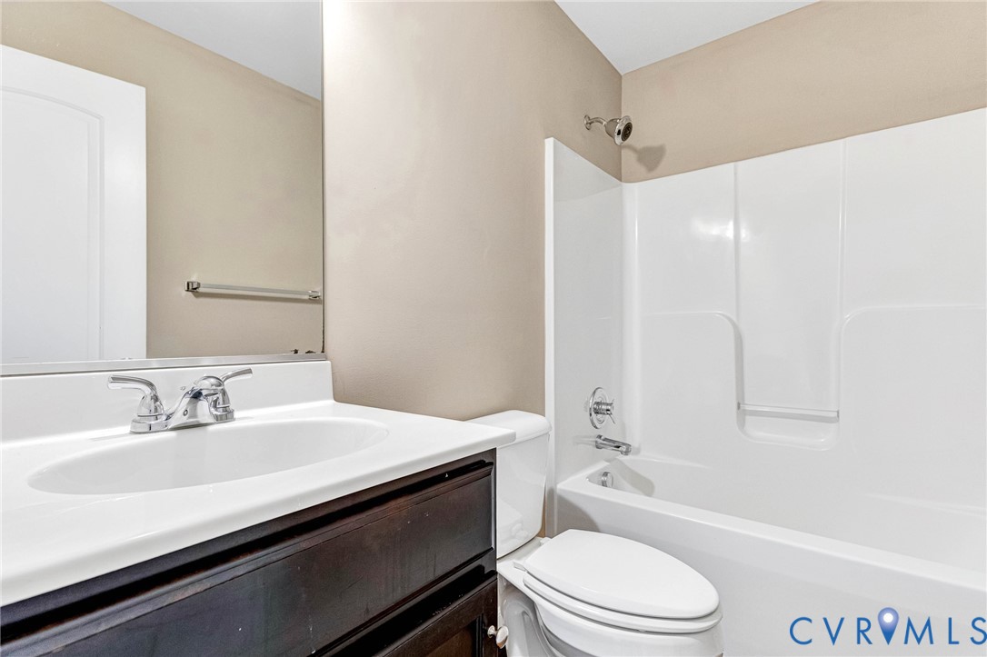 9925 Reymet Court Richmond, VA 23237 - Photo 22 of 30 a bathroom with a sink a toilet and a bathtub