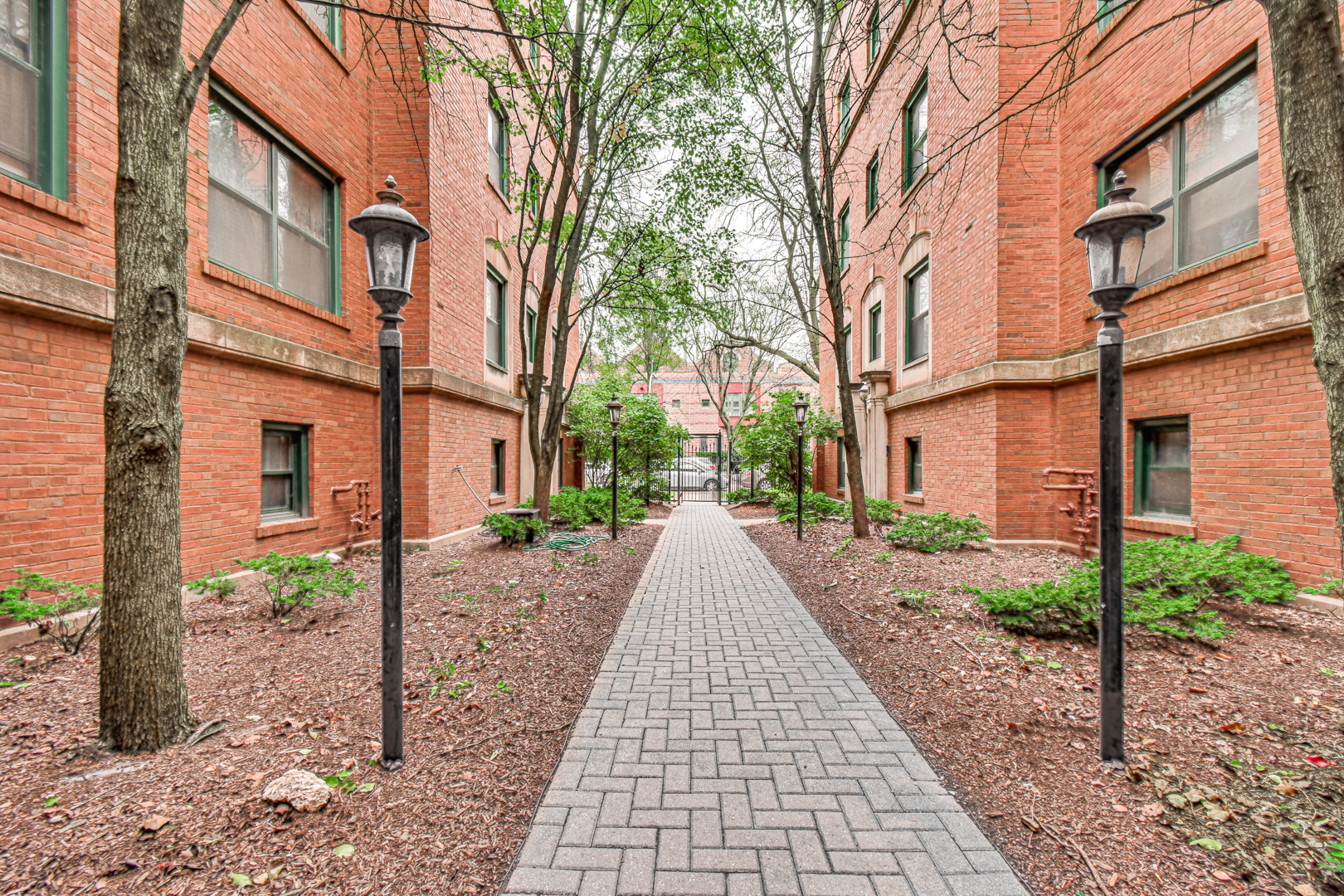 5252 South Drexel Avenue, Unit 3A Chicago, IL 60615 - Photo 4 of 6 a view of a brick building next to a yard