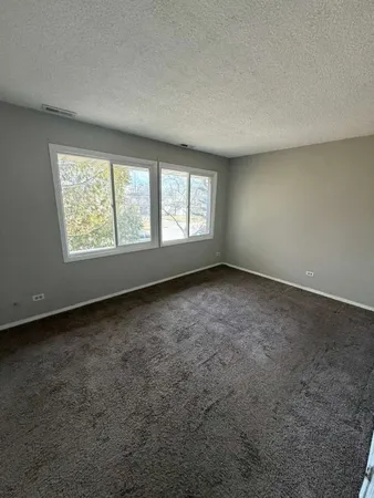 an empty room with a empty space and windows