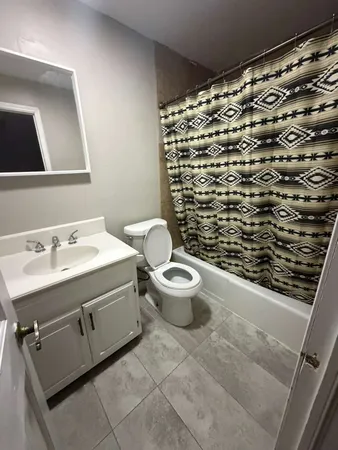 a bathroom with a sink toilet and shower