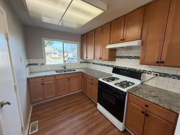 a kitchen with a stove a sink and a microwave