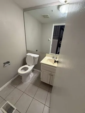 a bathroom with a sink toilet and mirror