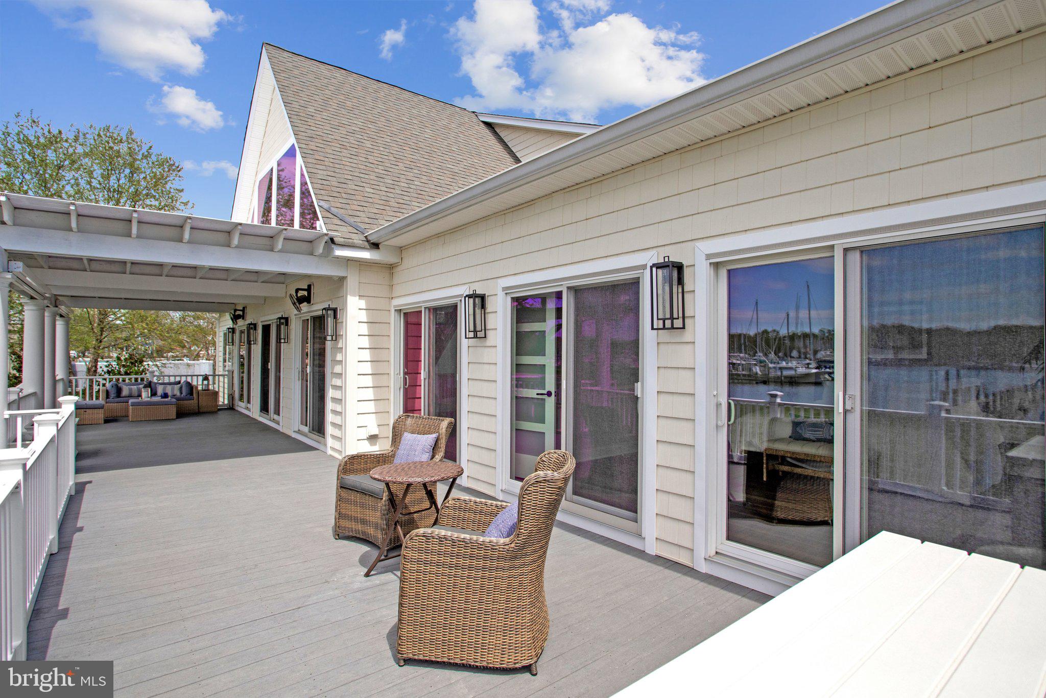 6146 Drum Point Road Deale, MD 20751 - Photo 67 of 75 a view of a patio with table and chairs potted plants with floor to ceiling window and potted plants