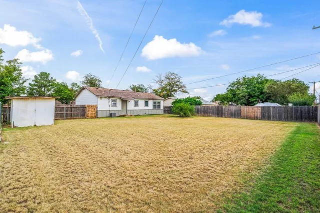 a house view with swimming pool and wooden fence