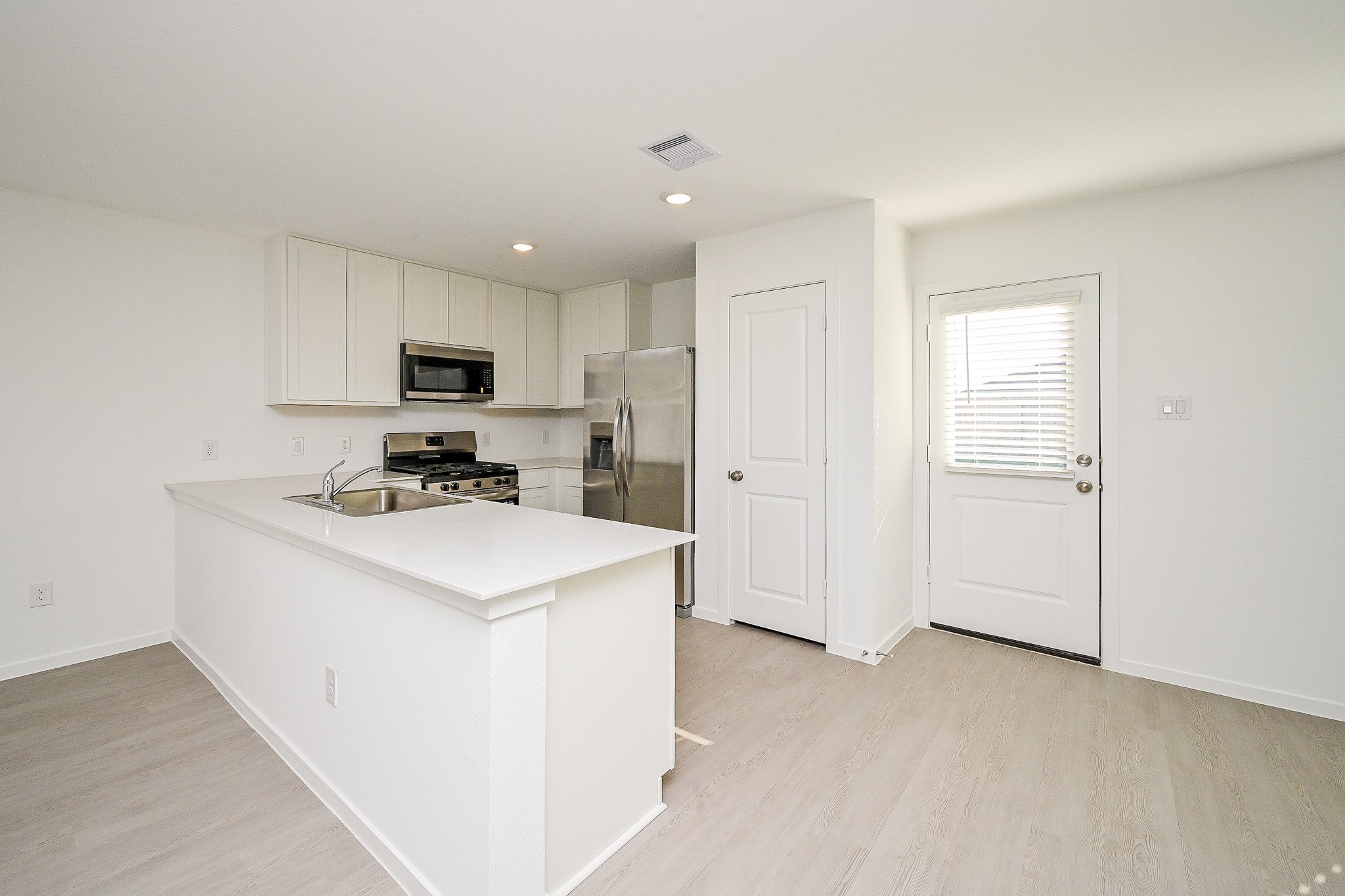 6818 Flowering Ginger Lane Katy, TX 77493 - Photo 23 of 47 a kitchen with a refrigerator a stove top oven a sink and dishwasher