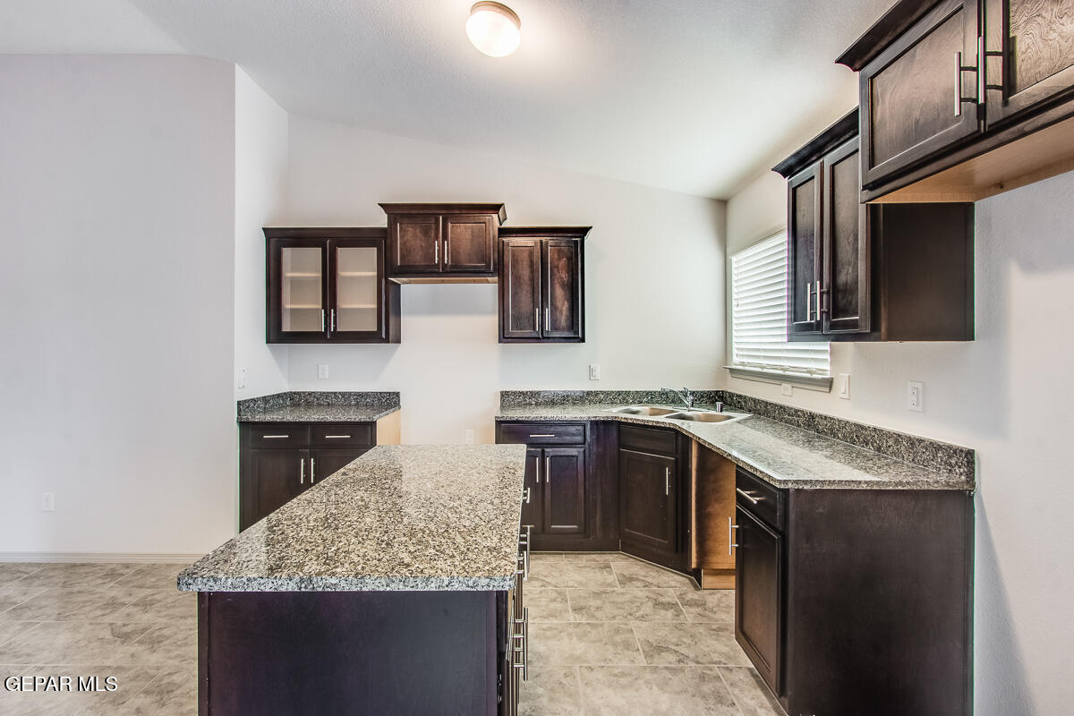 12420 Oconee Place Clint, TX 79836 - Photo 17 of 27 a kitchen with stainless steel appliances granite countertop stove microwave and cabinets