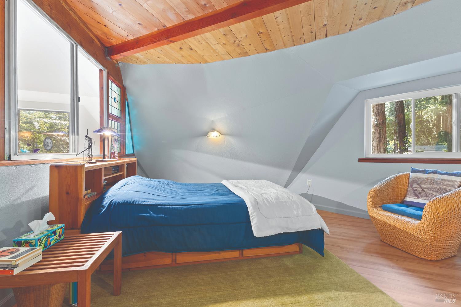 9085 Middle Terrace Monte Rio, CA 95462 - Photo 18 of 77 a bedroom with a bed and wooden floor