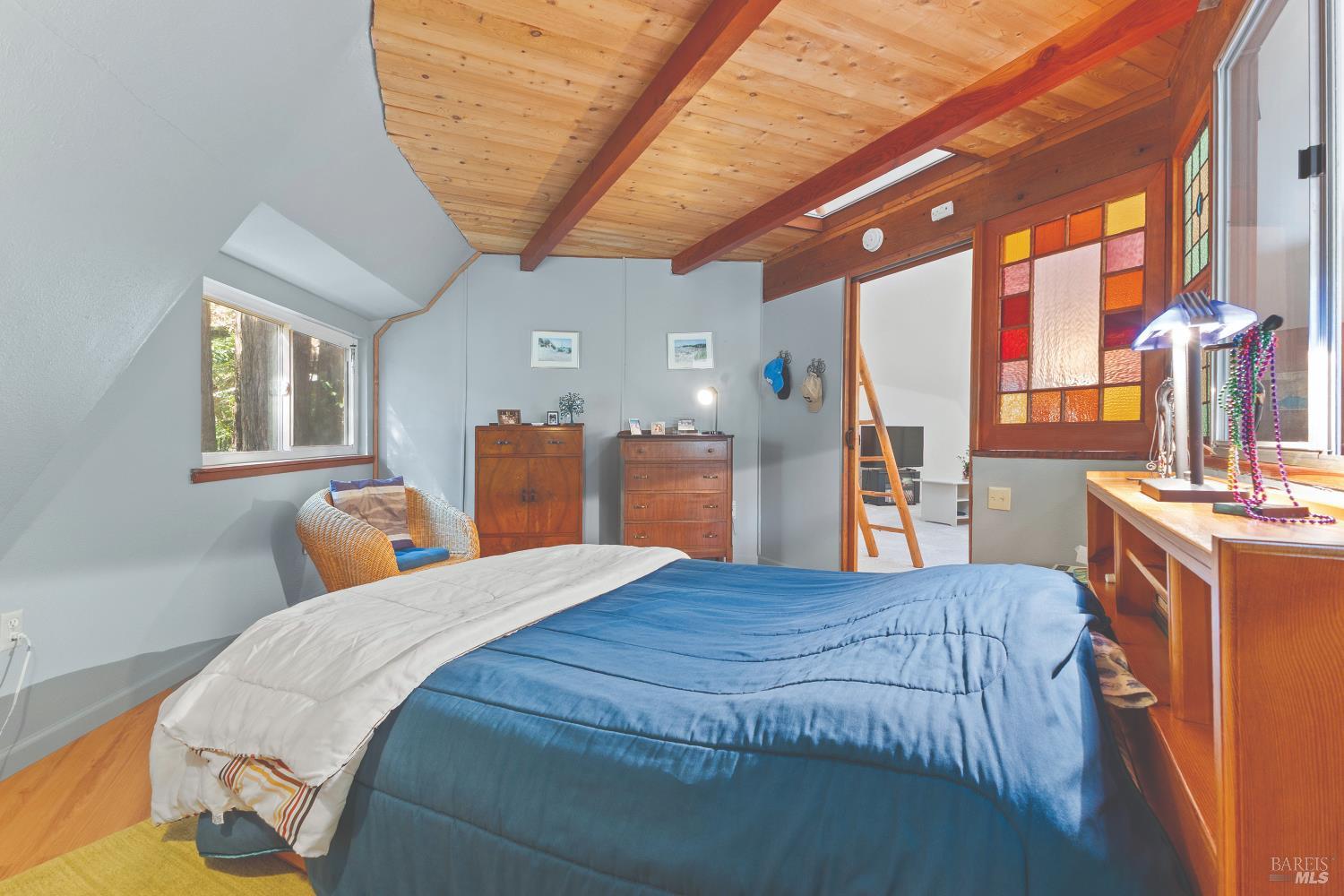 9085 Middle Terrace Monte Rio, CA 95462 - Photo 21 of 77 a bedroom with a bed closet and wooden floor