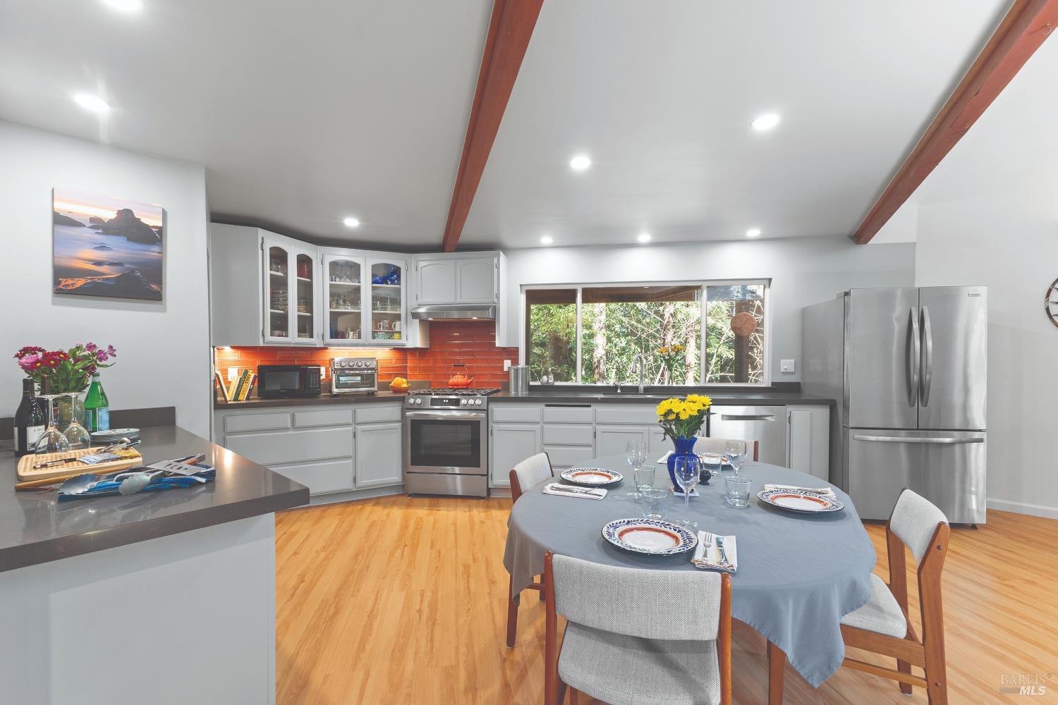 9085 Middle Terrace Monte Rio, CA 95462 - Photo 25 of 77 a kitchen with stainless steel appliances granite countertop a stove and white cabinets