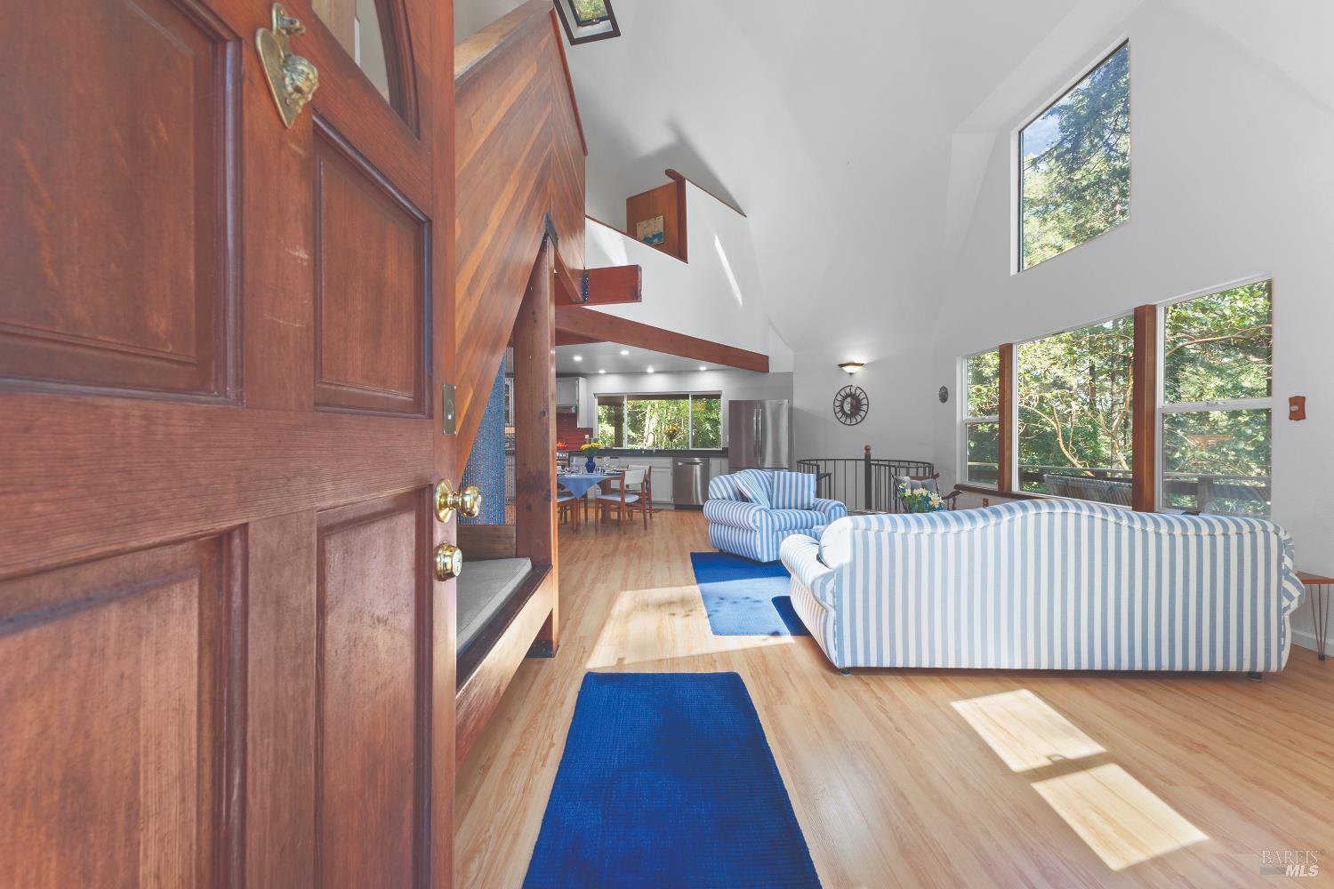 9085 Middle Terrace Monte Rio, CA 95462 - Photo 7 of 77 a view of a bedroom with wooden floor & windows