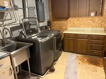 a kitchen with a sink stove and cabinets