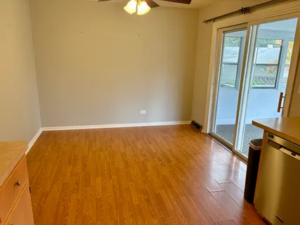 a view of an empty room and wooden floor