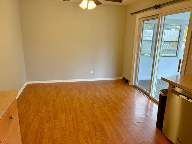 a view of an empty room and wooden floor