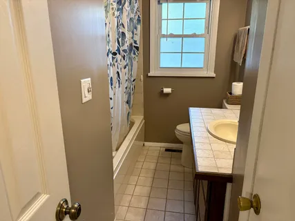 a bathroom with a toilet a sink and a mirror