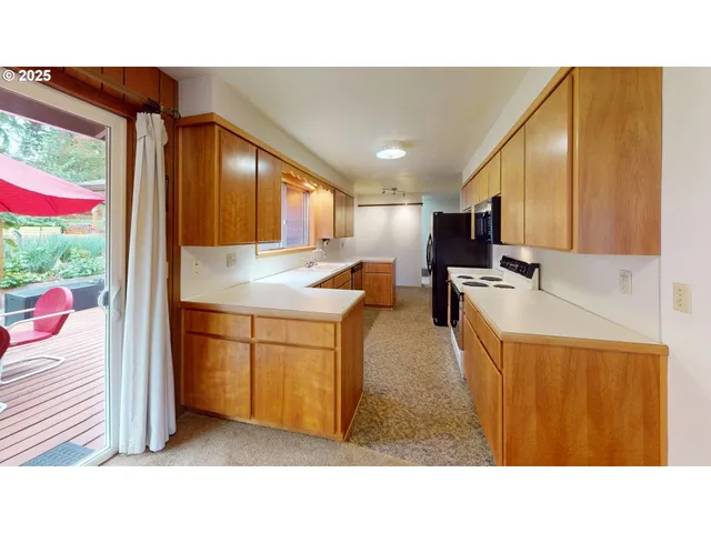 a kitchen with a refrigerator a sink dishwasher and wooden cabinets