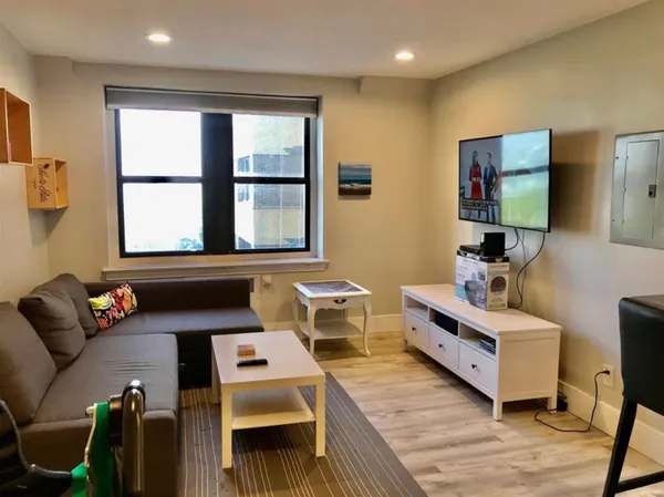 a living room with furniture and a window