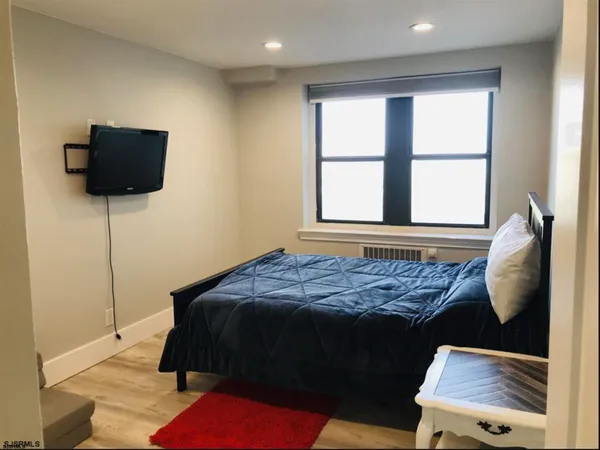 a bed sitting in a bedroom next to a window