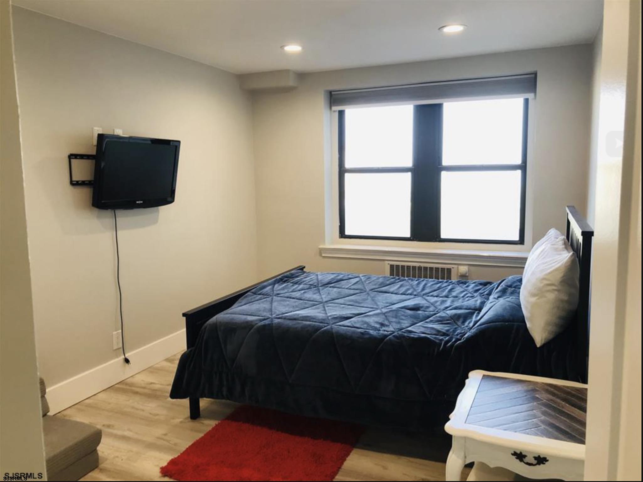 101 South Raleigh Avenue, Unit 325 Atlantic City, NJ 08401 - Photo 5 of 8 a bed sitting in a bedroom next to a window