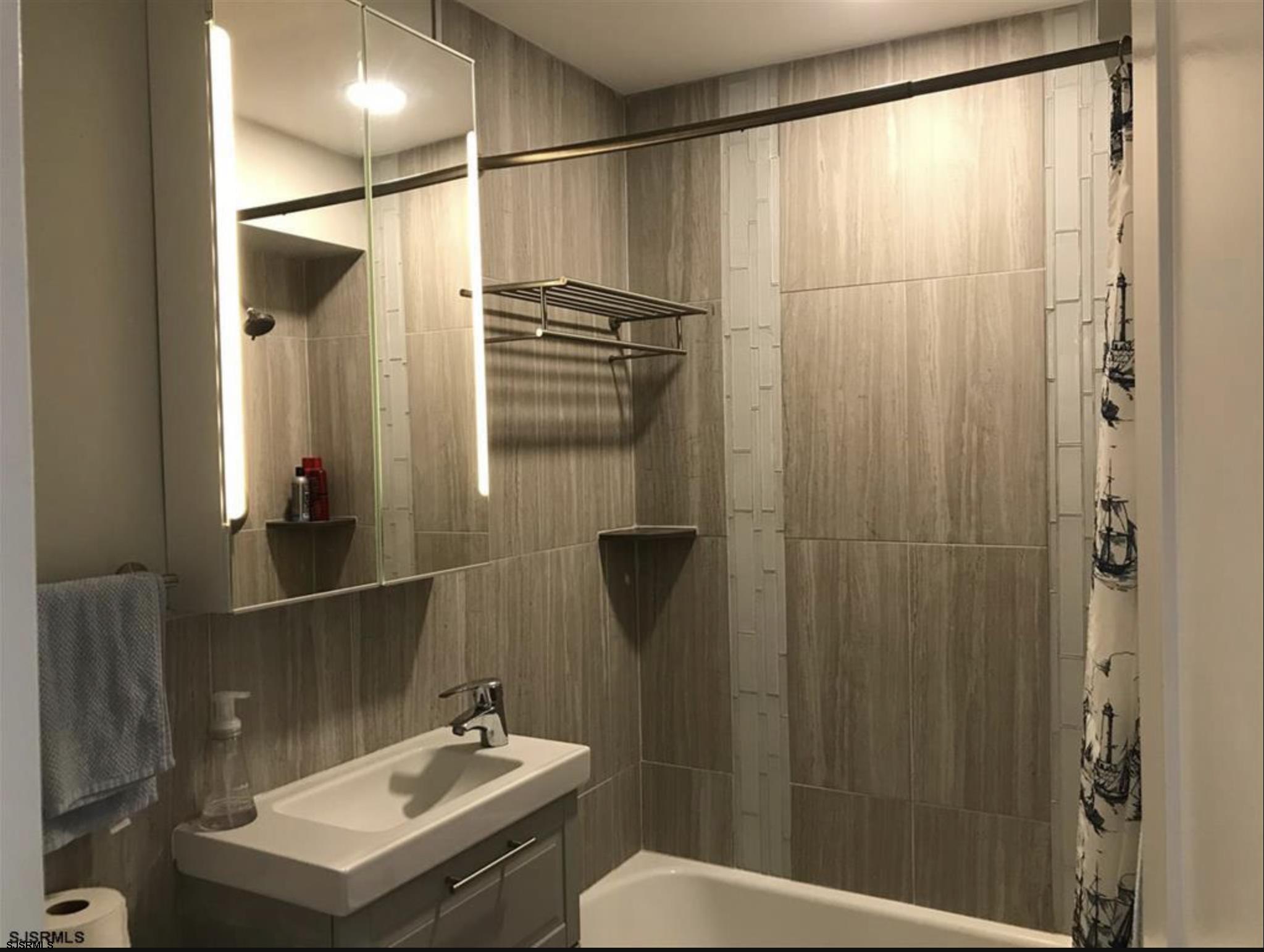 101 South Raleigh Avenue, Unit 325 Atlantic City, NJ 08401 - Photo 6 of 8 a bathroom with a sink and mirror