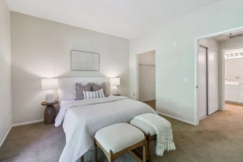 a bedroom with a bed and a chair