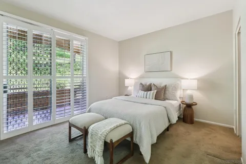 a bedroom with a bed and a window