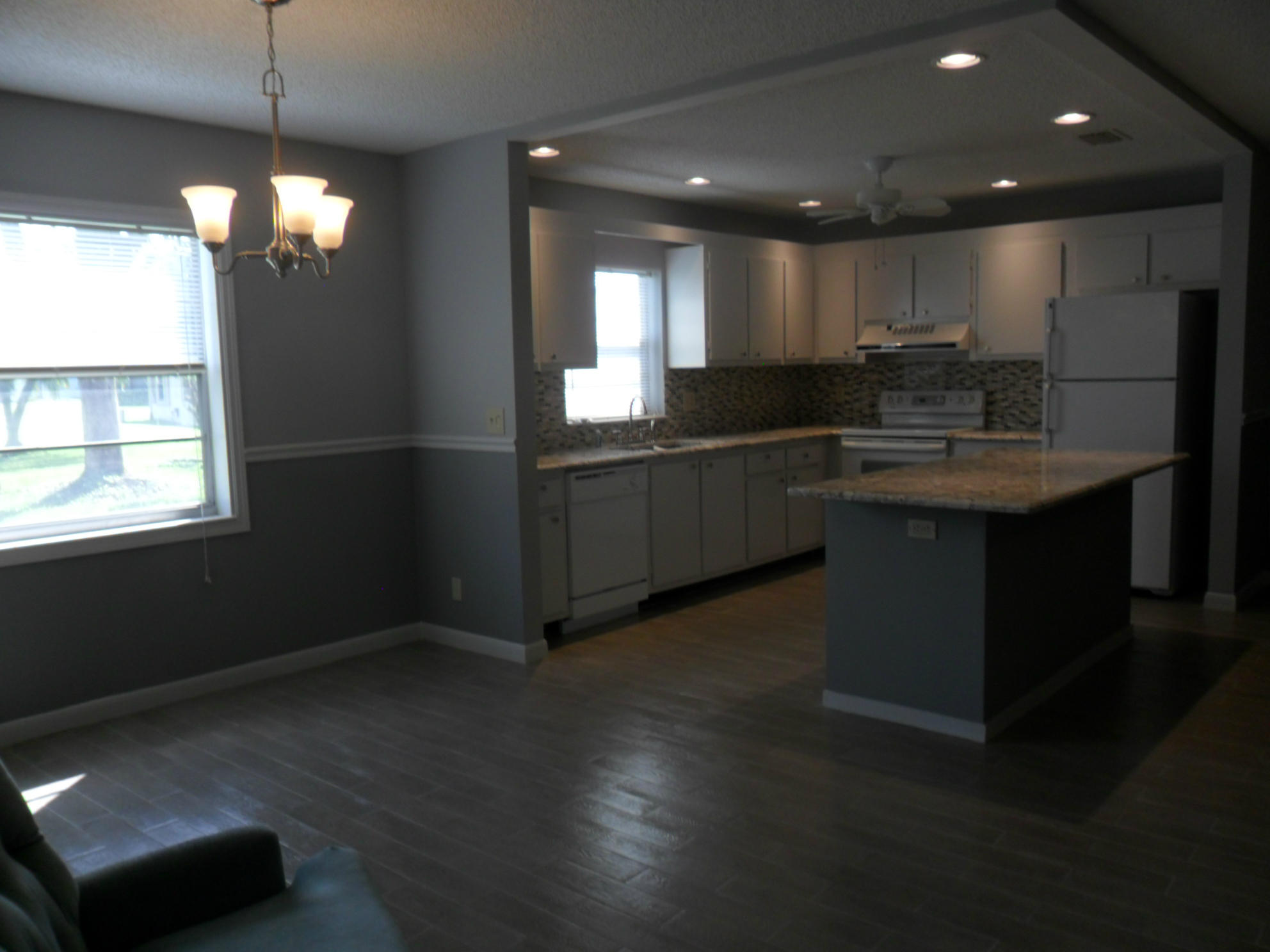 6311 Lasalle Road Delray Beach, FL 33484 - Photo 5 of 34 a kitchen with kitchen island stainless steel appliances a sink stove and cabinets