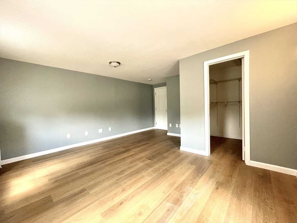 46-52 Main Street, Unit 2R Framingham, MA 01702 - Photo 6 of 7 a view of an empty room with wooden floor