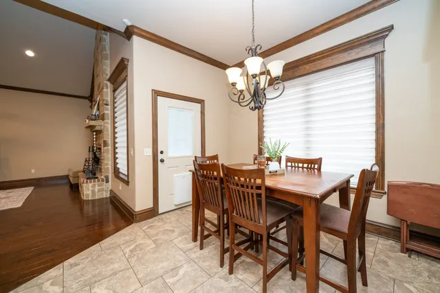 a view of a dining room with furniture and chandelier