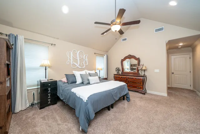 a bedroom with a bed and a chandelier