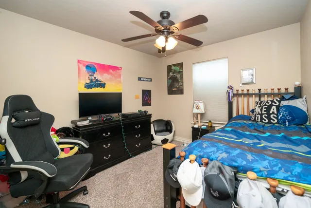 a bedroom with a bed and a flat screen tv