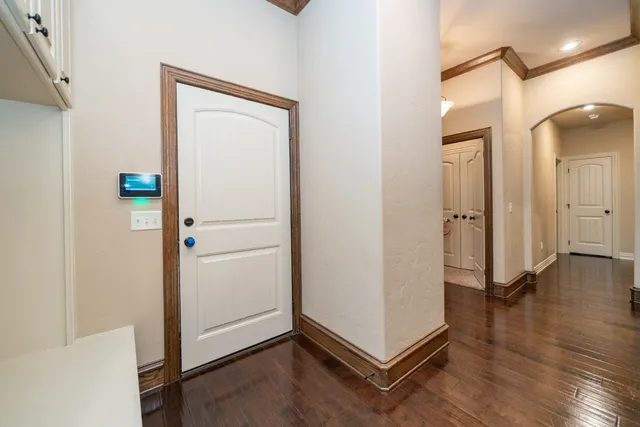 a view of a room with wooden floor