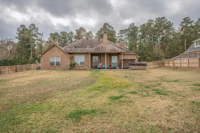 a view of a house with a yard and potted plants