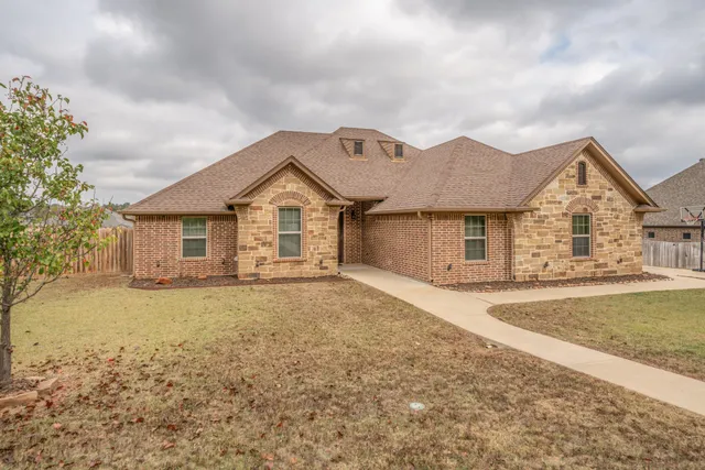 a front view of a house with a garden