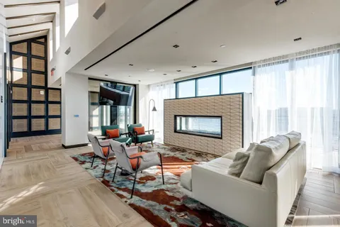 a living room with furniture and floor to ceiling window